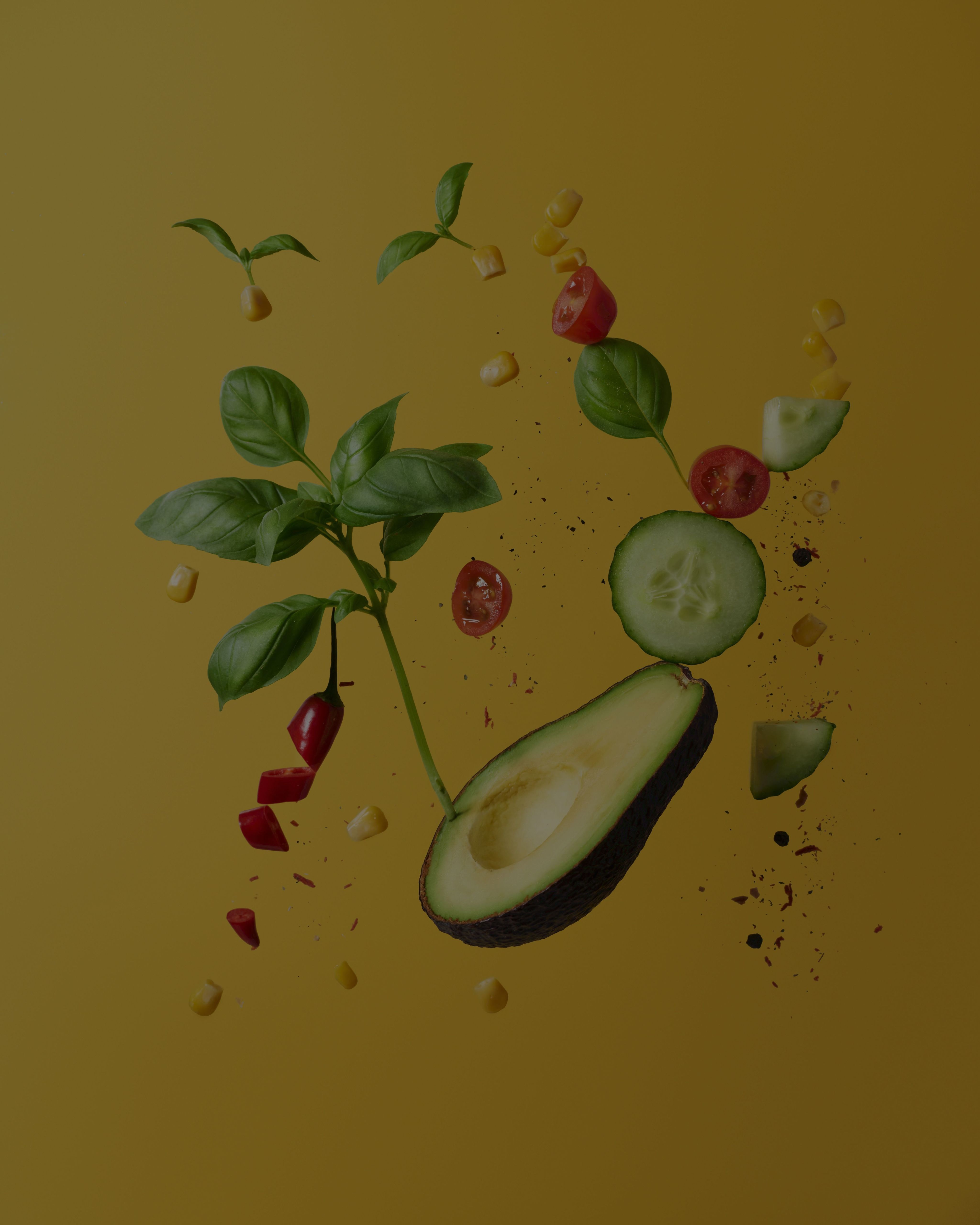 Vegetables falling on a yellow background. 