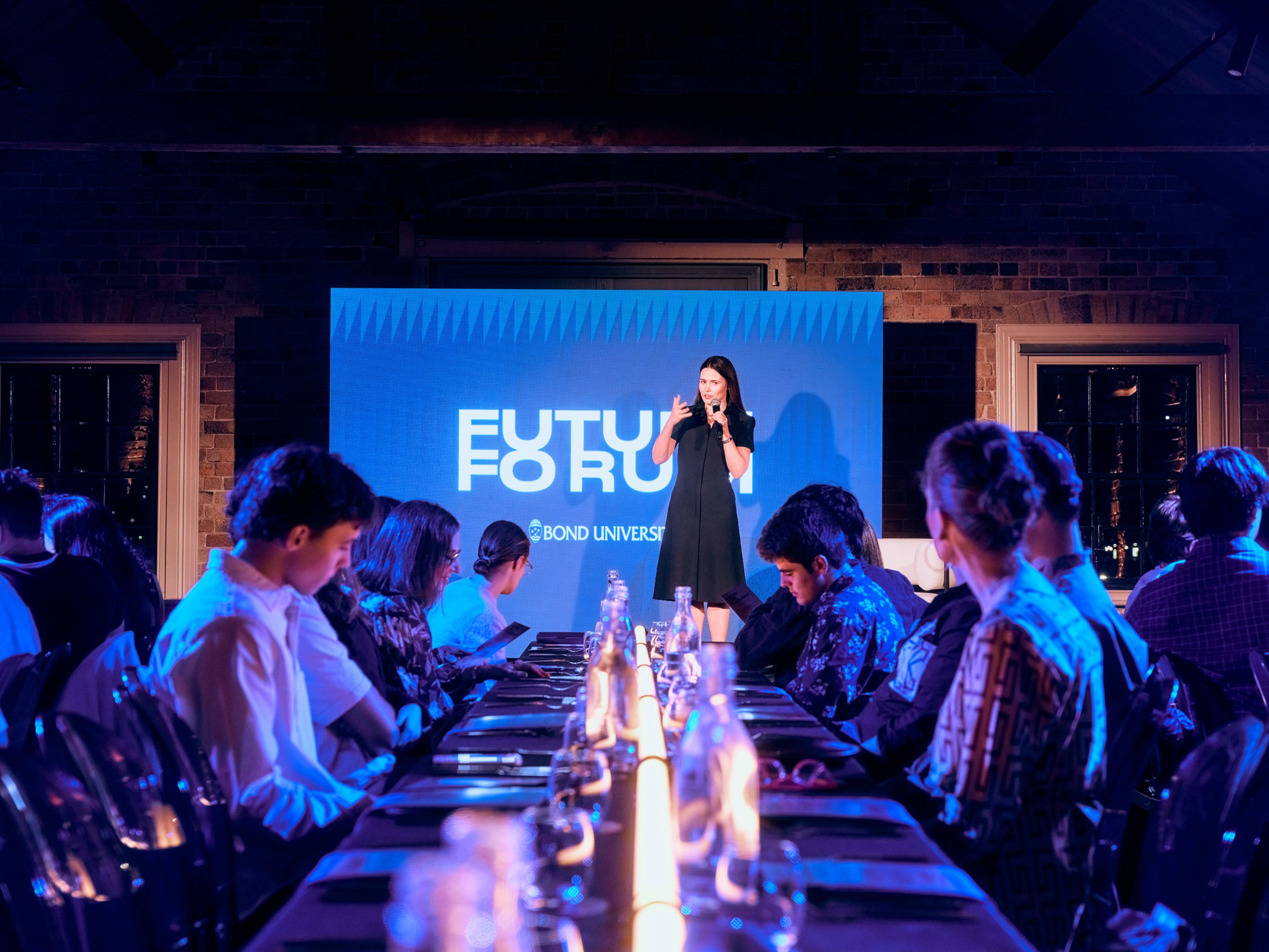 A woman is speaking on a stage.