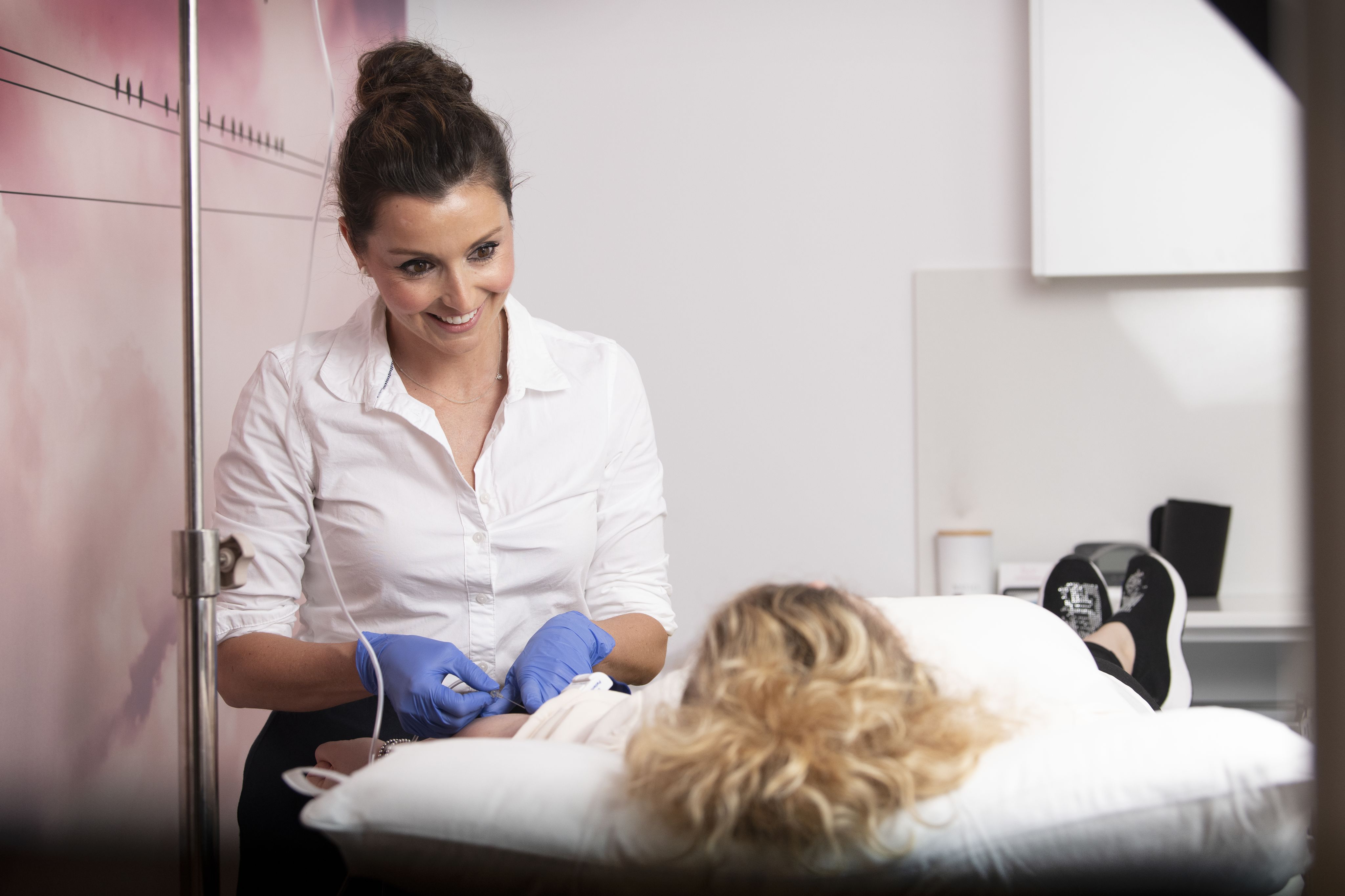 A doctor is looking down at her patient.