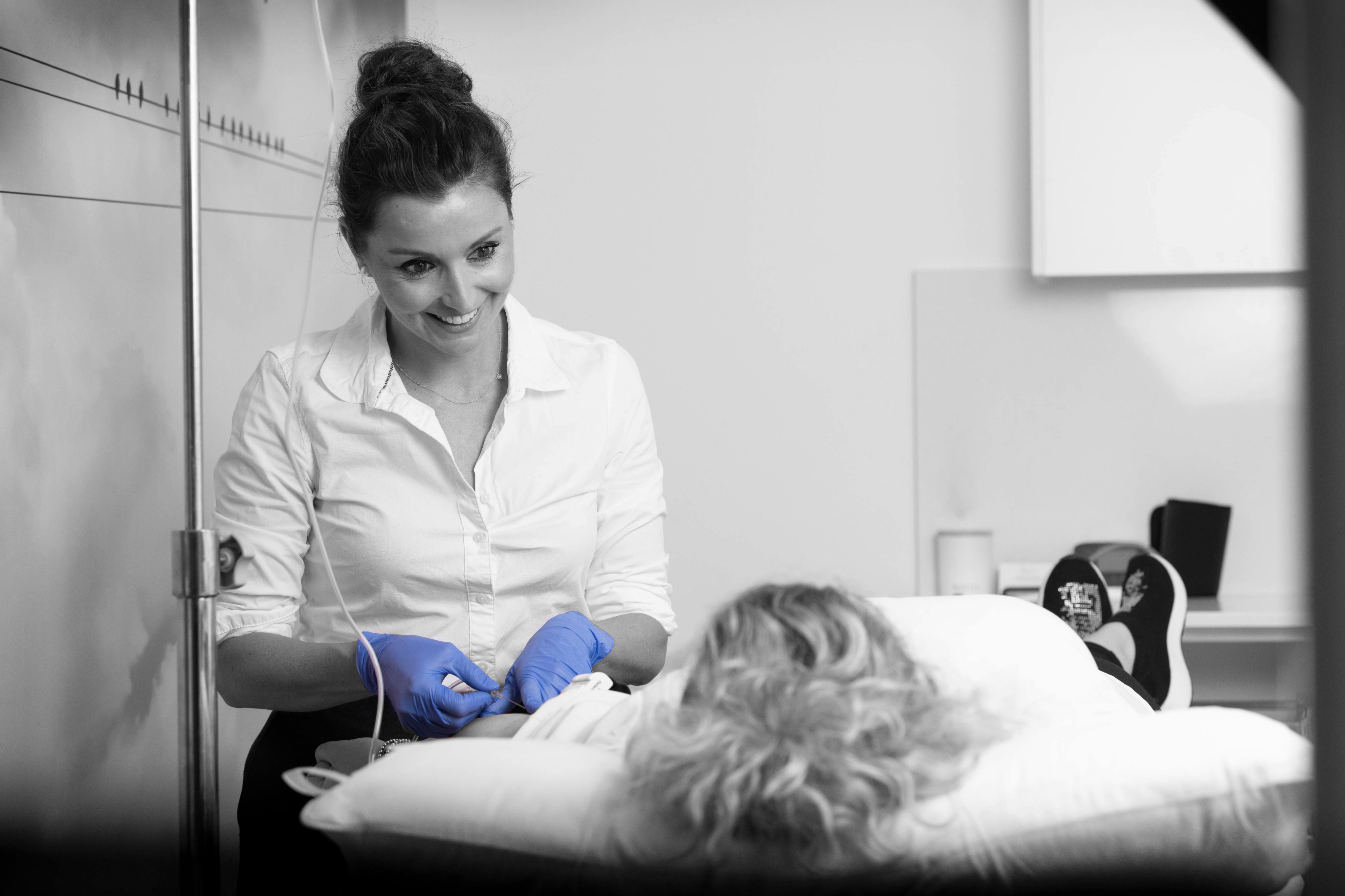 A doctor is looking down at her patient.