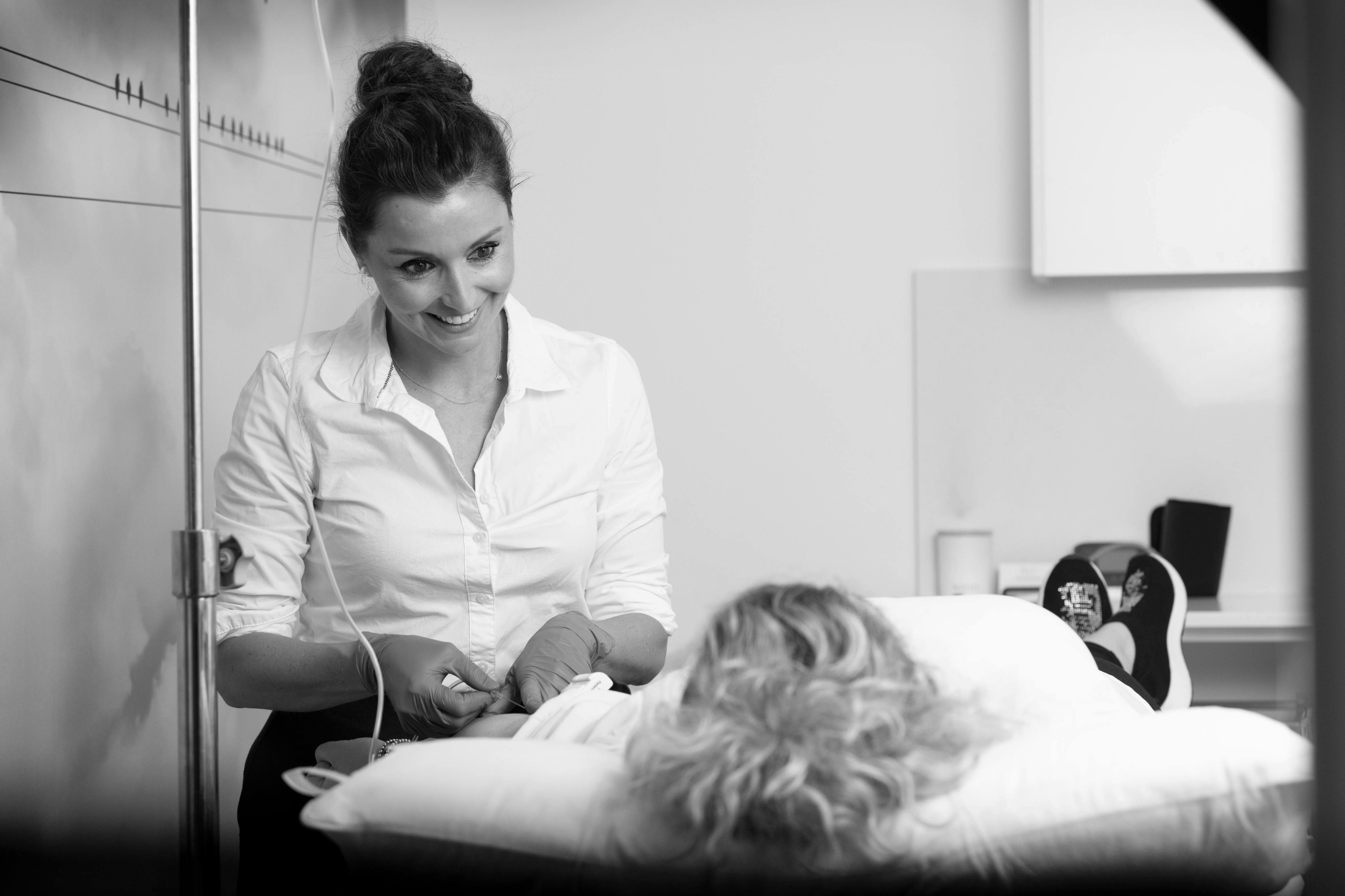 A doctor is looking down at her patient.