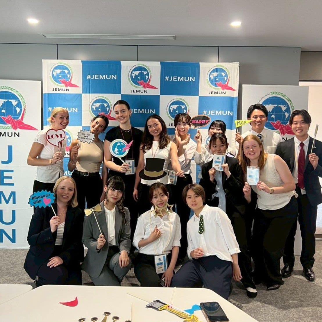 Four young adults are sitting on a train.