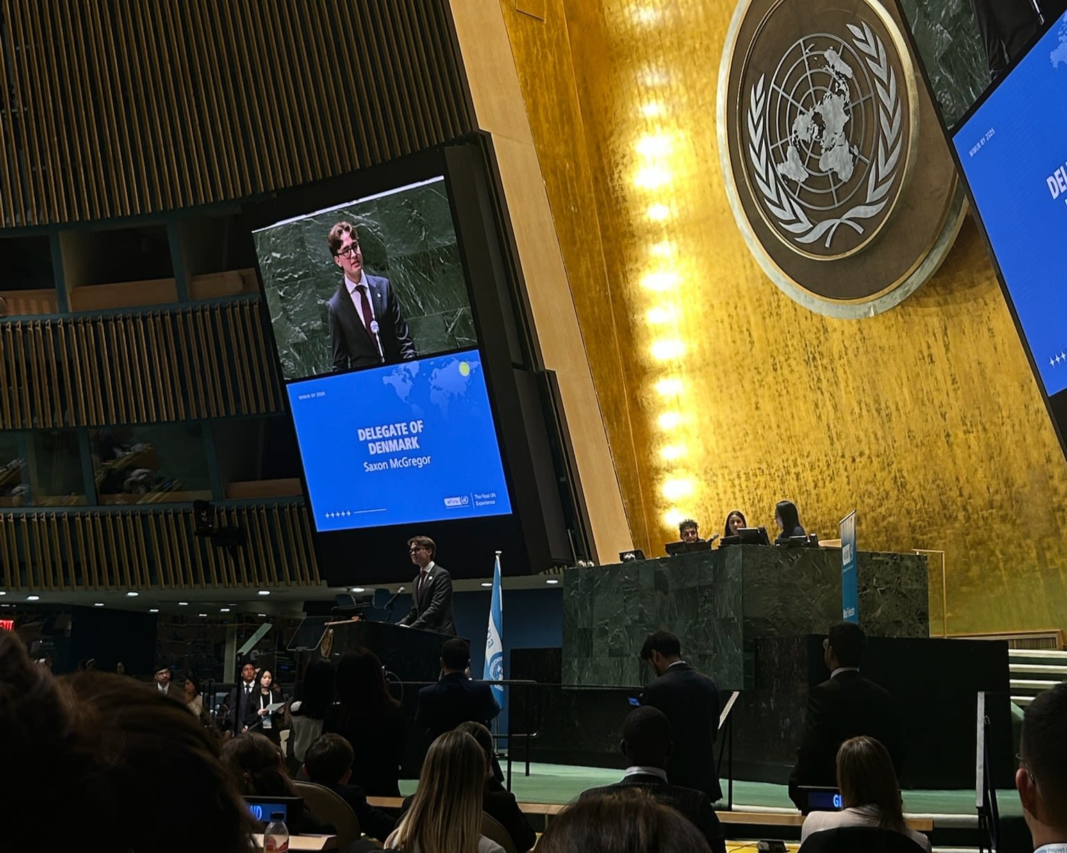 A young man at a lecturn.