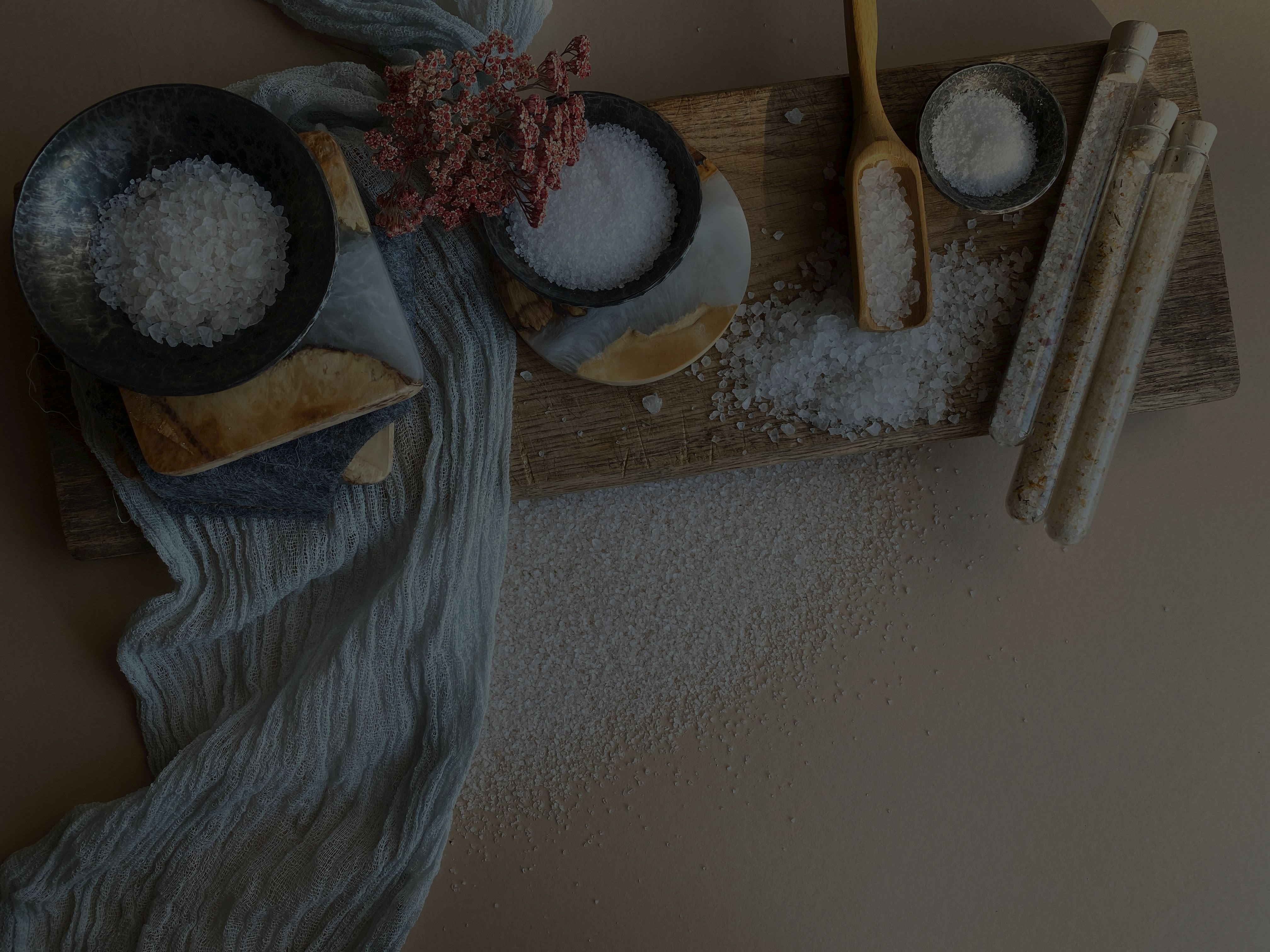 Bowls of salt on a chopping board.