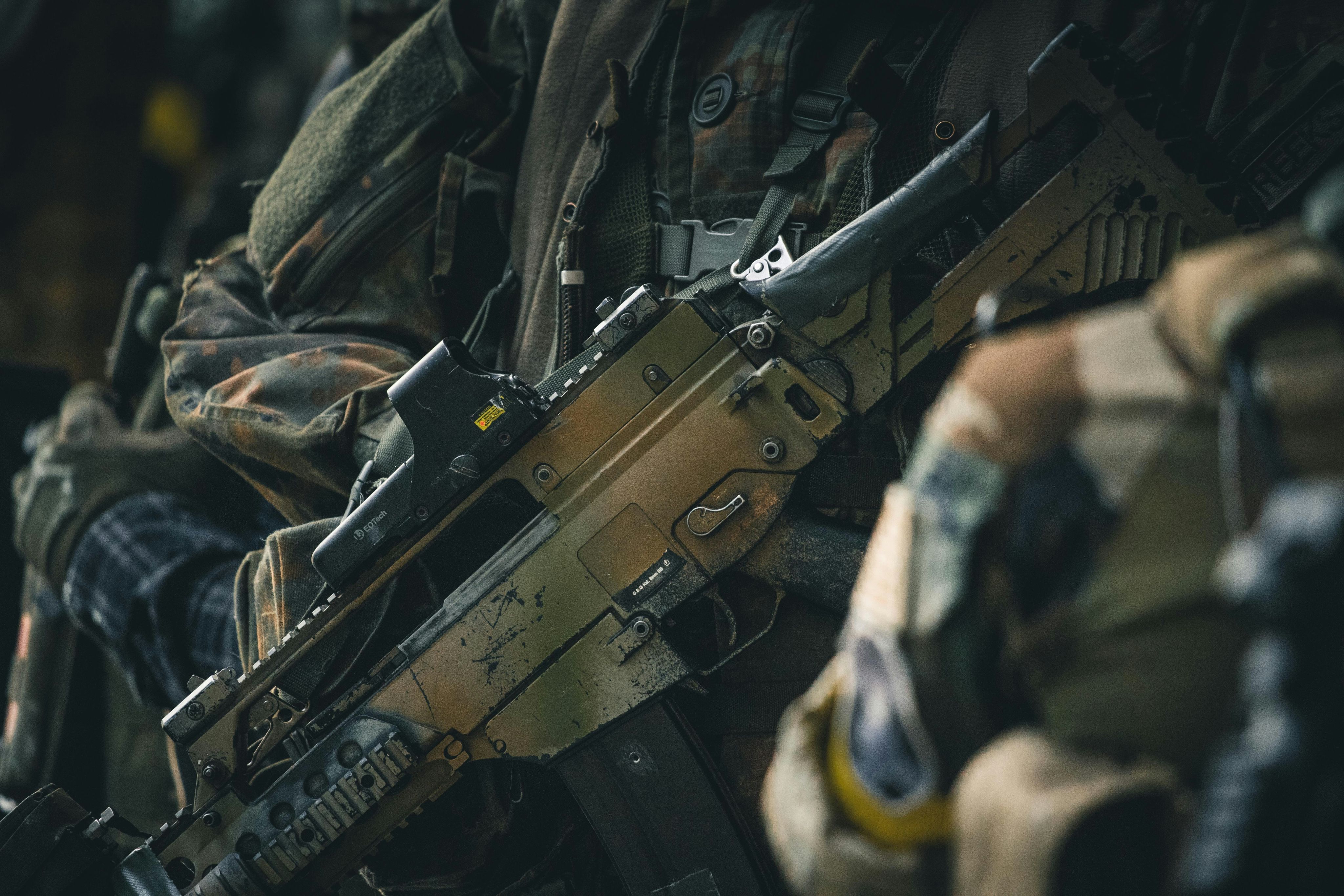 a close up of a rifle on a person's arm