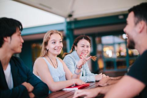 Blonde girl smiling around a group of people at Dons Tavern