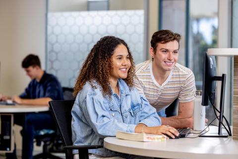 Teacher and a student at a computer in the Nyombil Centre