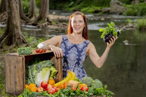 Dr Megan Lee holding fresh fruit and vegetables