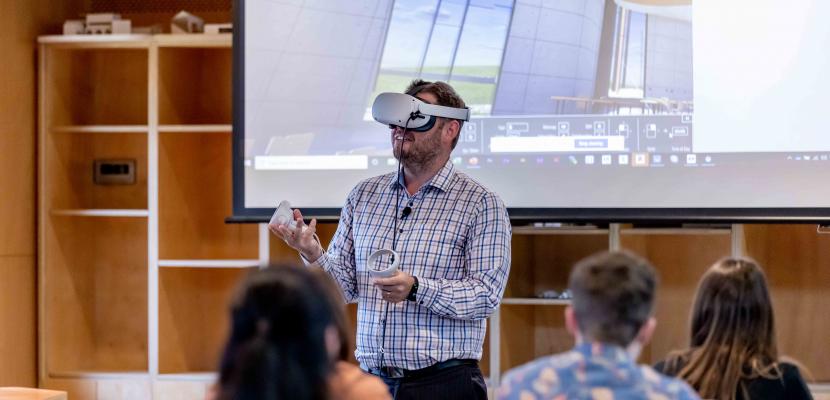 James Birt wearing virtual reality equipment in a classroom.
