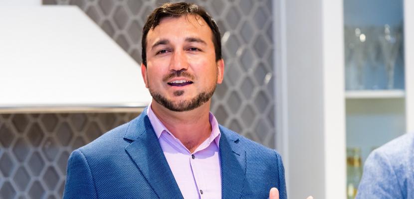 David Stevens-Castro is depicted in a close up shot. He is talking and gesturing with his hands. 