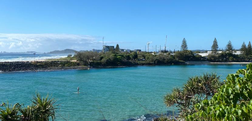 A beautiful view of clear blue water, blue sky, and greenery