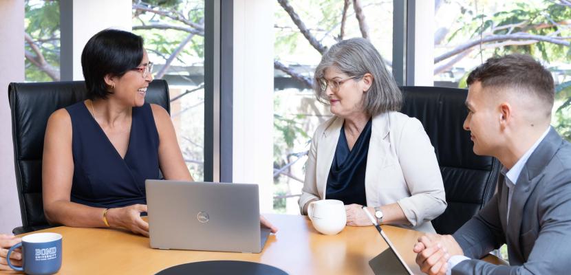 A group of law students and teachers in the boardroom