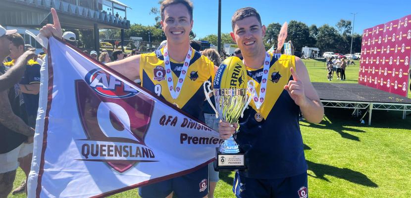 Tom Sanders celebrates a premiership with teammate. 