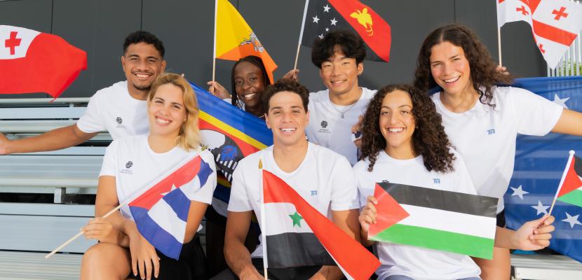 WA swimmers in stands with flag
