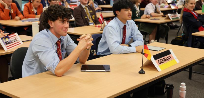 Students at a desk with Germany flag in front of them