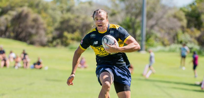 Men's rugby 7's player running to score try