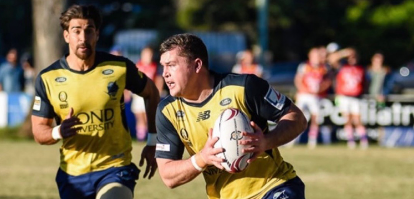 Men's rugby player, Connor Pritchard, running with the ball in his hand