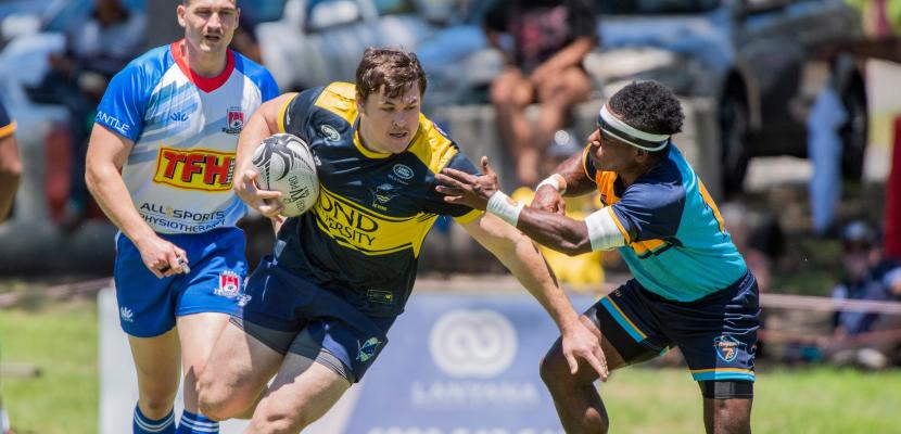 Three men playing rugby