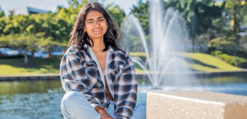 Sara Fagan smiling in front of the Bond University fountain