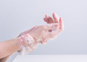 A person washes their hands with soap